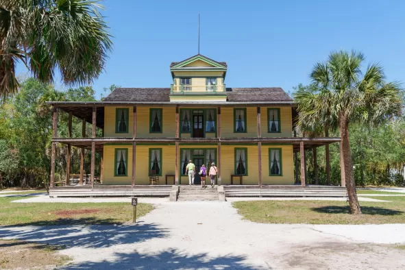 A group explores a historic building at Koreshan State Park
