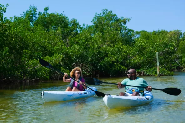 A couple paddles through the pristine backwaters