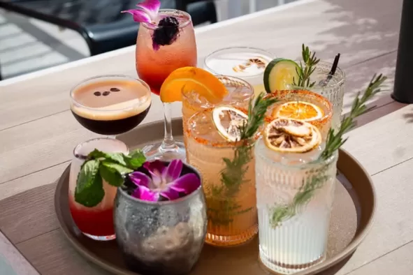 A tray of craft cocktails at Rooftop at Riverside