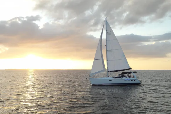 Sailing vessel Orion's Child sails across the water in Fort Myers Beach