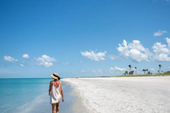 A woman walks along the beach