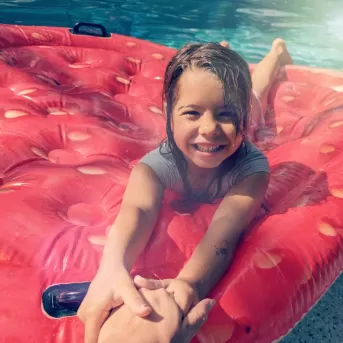 Child playing in pool