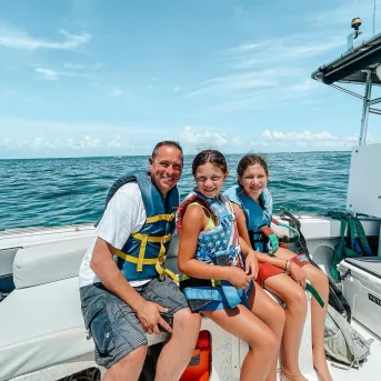 A father and daughters enjoy boating