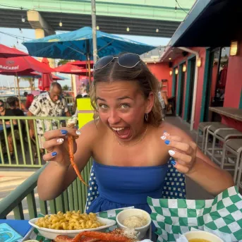 A woman is excited about eating seafood
