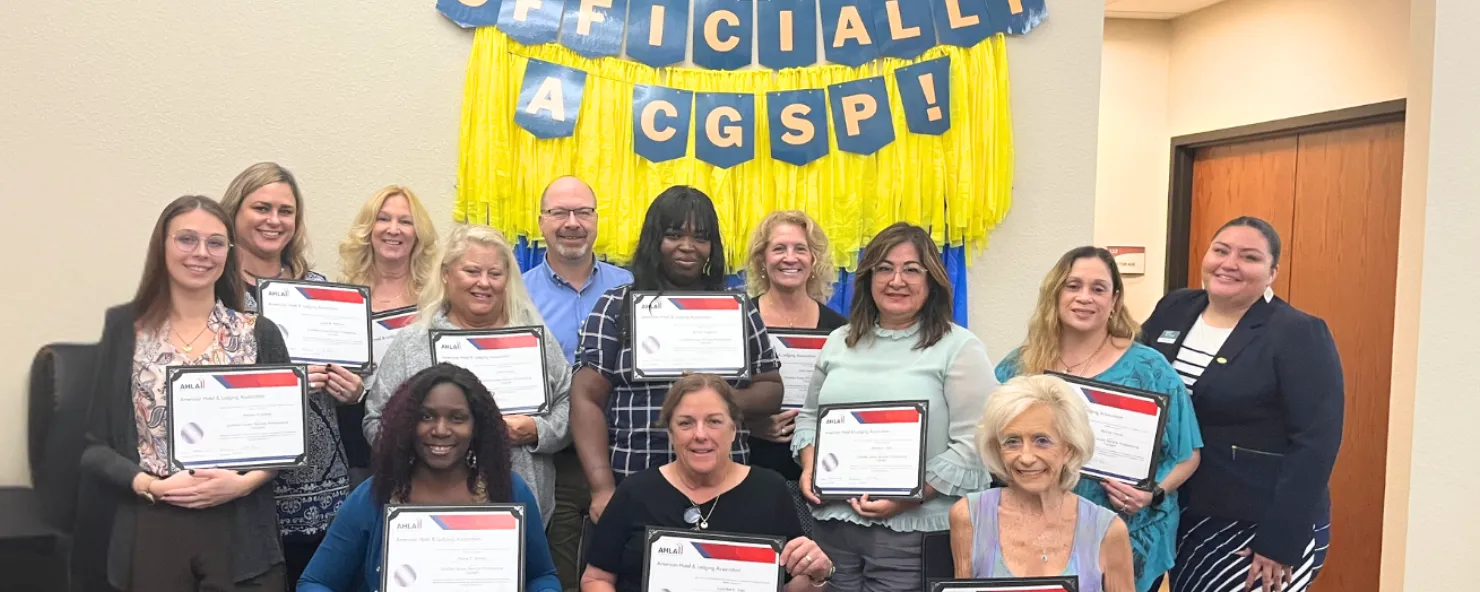 Guests First graduates show off their certificates