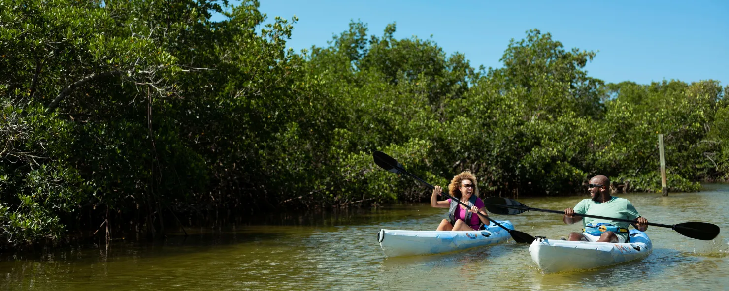 A couple paddles through a nature preserve