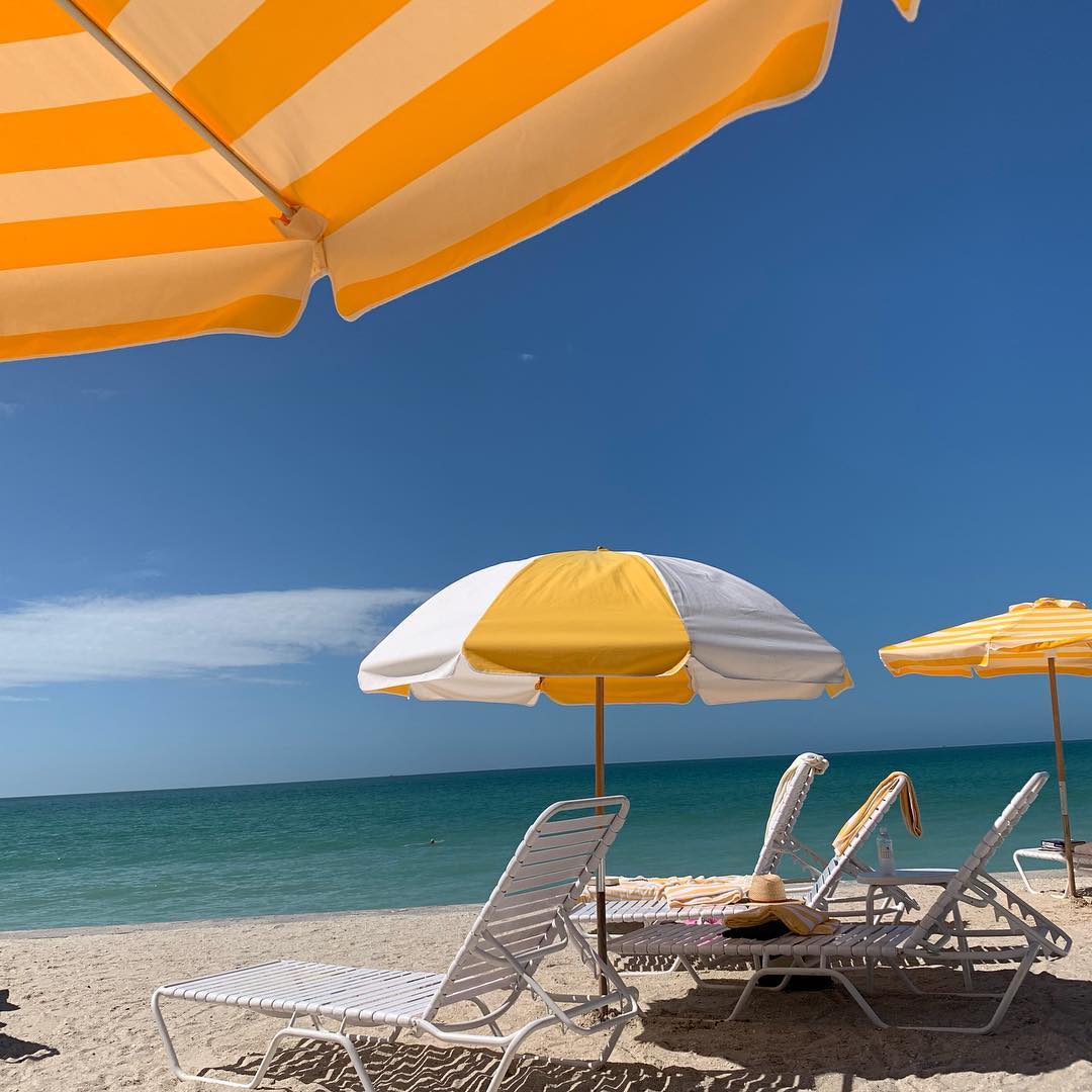 Yellow and white striped umbrellas on a Boca Grande Beach