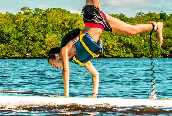 Hand stand on a surfboat